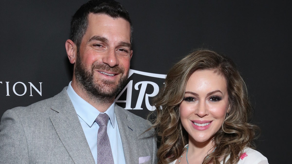 Alyssa Milano (right) and her husband Dave Bugliari (left). The actress said that her husband called the police to ask when they'd be arriving after a neighbor made the initial call to law enforcement. (Photo by Rich Fury/Getty Images)