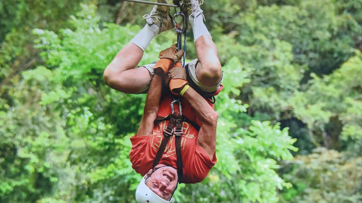 Woidislawsky, pictured ziplining before contracting COVID-19, was born in the Siberian mountains after his parents fled the Nazis.