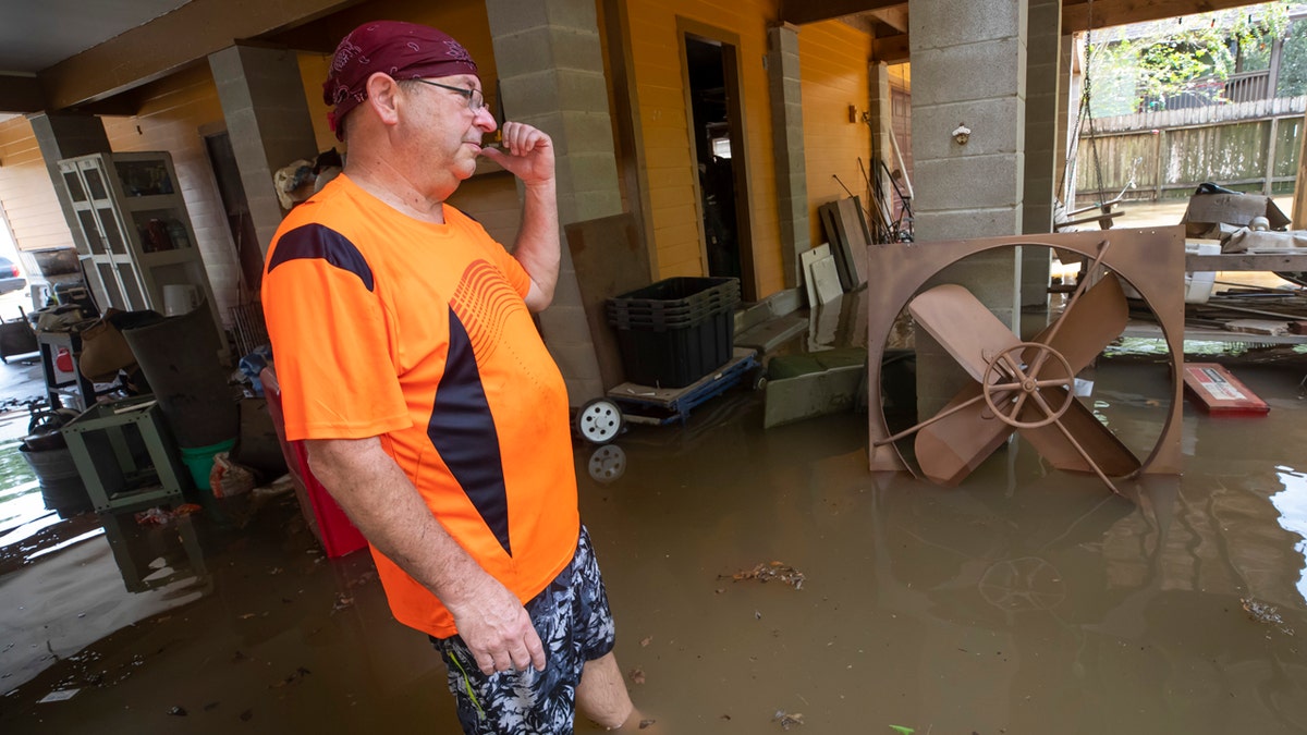 Lance Lindsley stands in the flooded garage of his house on Appleblossom Lane in Friendswood, Texas on Tuesday, Sept. 22, 2020, following Tropical Storm Beta.