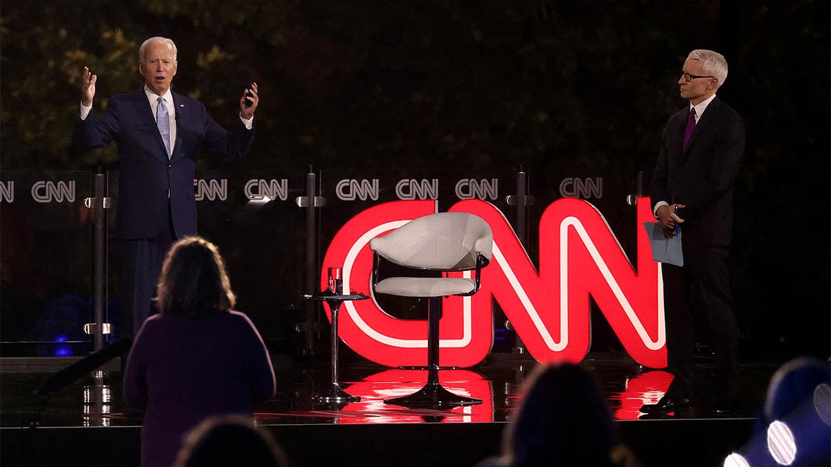 Democratic U.S. presidential nominee and former Vice President Joe Biden kept his distance from CNN host Anderson Cooper until a commercial break.  (REUTERS/Jonathan Ernst)