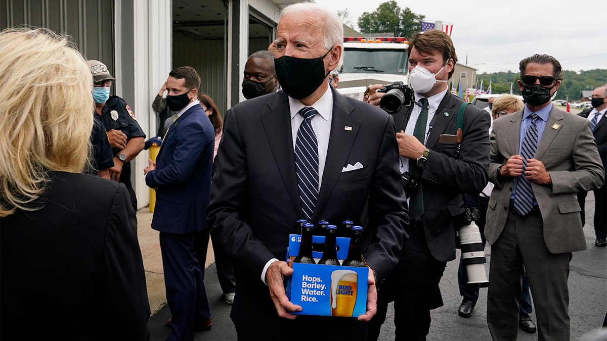 Democratic presidential candidate and former Vice President Joe Biden delivers beer as he and his wife Jill Biden visit the Shanksville Volunteer Fire Department in Shanksville, Pa., Friday, Sept. 11, 2020. The Bidens stopped by after visiting the nearby Flight 93 National Memorial to commemorate the 19th anniversary of the Sept. 11 terrorist attacks. (AP Photo/Patrick Semansky)