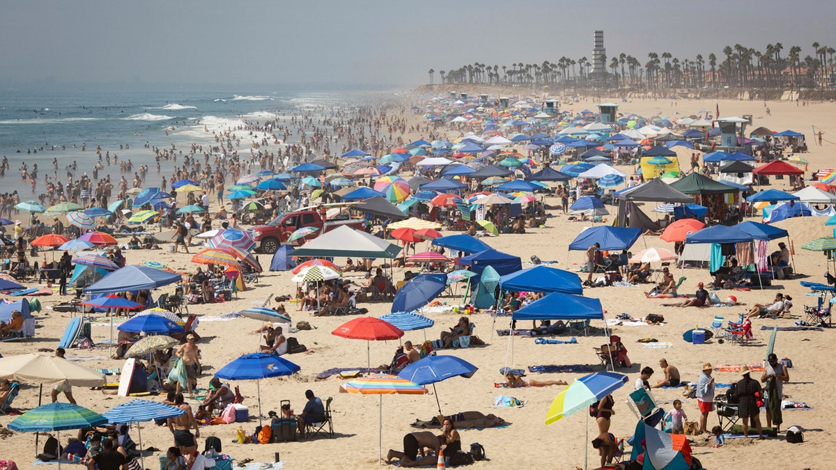People escape the California heat wave at the beach, Sunday, Sept. 6, 2020, in Huntington Beach, Calif.