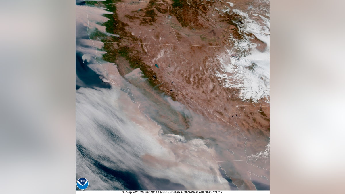 This satellite image provided by the National Oceanic and Atmospheric Administration at 20:36 UTC (1:36 pm PDT) shows smoke from wildfires blown westward, from California's Sierra Nevada to the Coast Ranges, at center to left, and from Oregon at top left, Tuesday, Sept. 8, 2020.