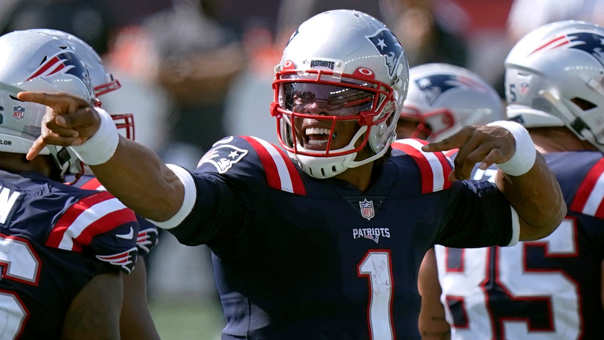 New England Patriots quarterback Cam Newton signals a first down in the second half of an NFL football game against the Miami Dolphins, Sunday, Sept. 13, 2020, in Foxborough, Mass. (AP Photo/Steven Senne)