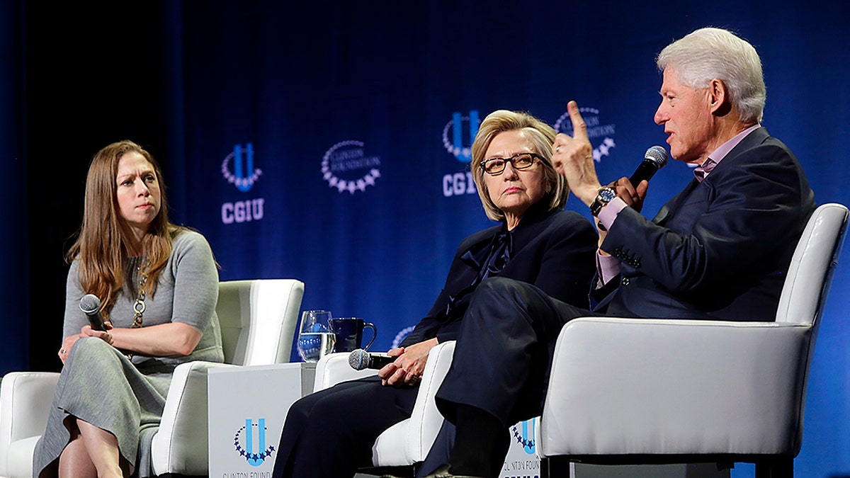 Chelsea Clinton and former Secretary of State Hillary Clinton listens as former President Bill Clinton speaks during the annual Clinton Global Initiative conference at the University of Chicago on Oct. 16, 2018 in Chicago. (Photo by Joshua Lott/Getty Images)