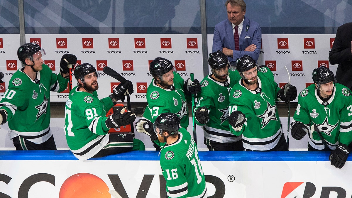 Dallas Stars center Joe Pavelski (16) celebrates his goal against the Tampa Bay Lightning with teammates on the bench during the first period of Game 4 of the NHL hockey Stanley Cup Final, Friday, Sept. 25, 2020, in Edmonton, Alberta. (Jason Franson/The Canadian Press via AP)