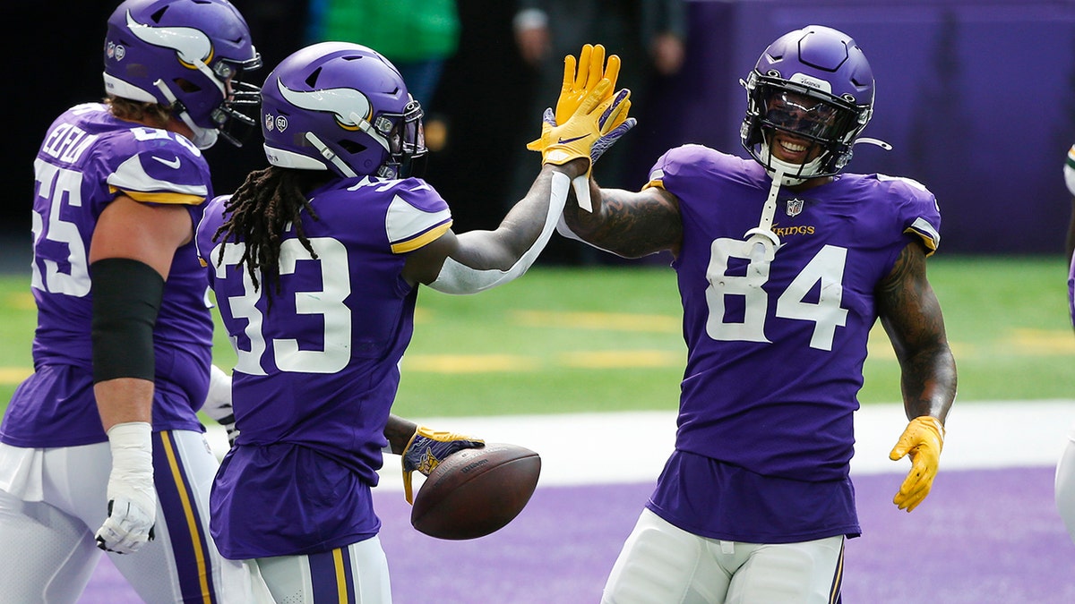 Minnesota Vikings running back Dalvin Cook celebrates with teammate Irv Smith (84) after scoring on a 1-yard touchdown run during the first half of an NFL football game against the Green Bay Packers, Sunday, Sept. 13, 2020, in Minneapolis. (AP Photo/Bruce Kluckhohn)