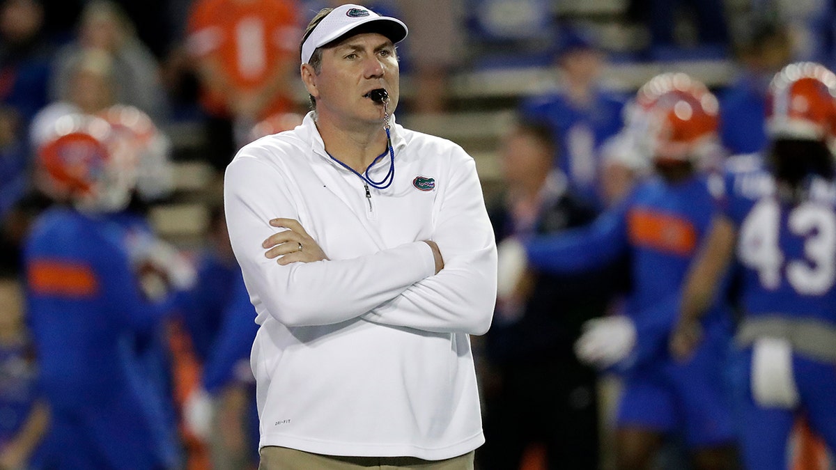 Florida head coach Dan Mullen watches his players warm up before an NCAA college football game against Florida State, in Gainesville, Fla. Mullen is still wary about what lies ahead as Florida prepares to open the season at Ole Miss on Saturday, Sept. 26, 2020. “Obviously, all the COVID stuff makes you anxious,” Mullen said. (AP Photo/John Raoux, File)