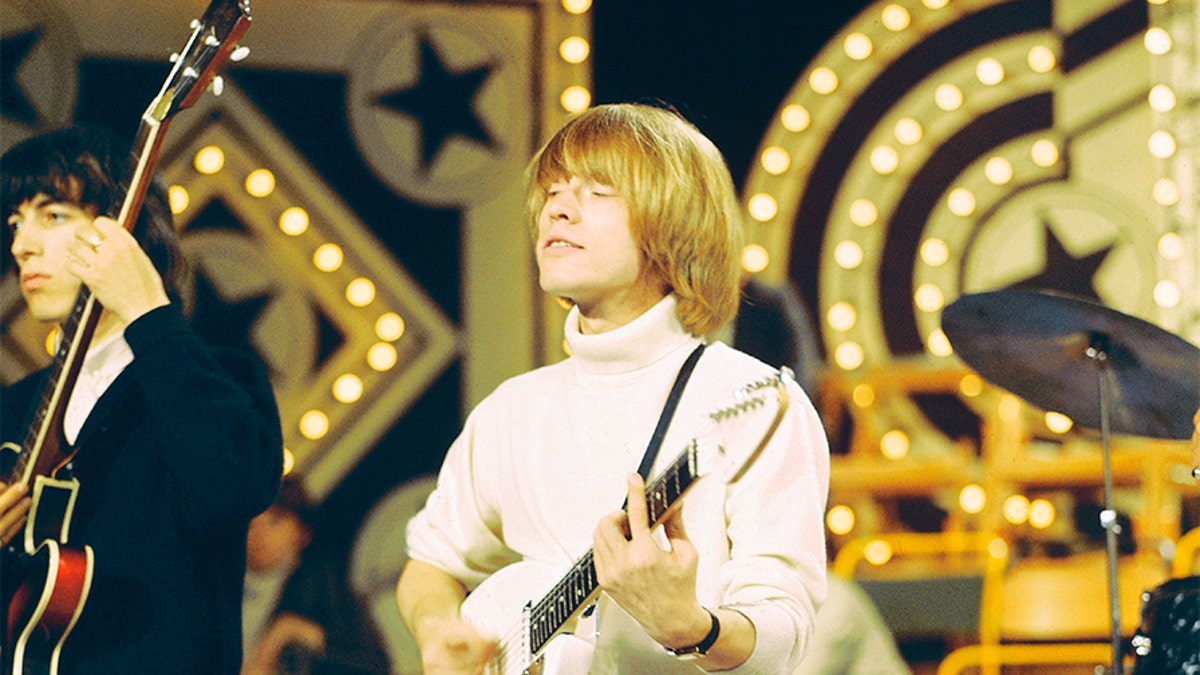 English musician and guitarist Brian Jones (1942-1969) of the rock group Rolling Stones plays a Vox Mark VI Teardrop guitar on the set of the ABC Television pop music television show 'Thank Your Lucky Stars' at Alpha Television Studios in Birmingham, England on 6th June 1965.