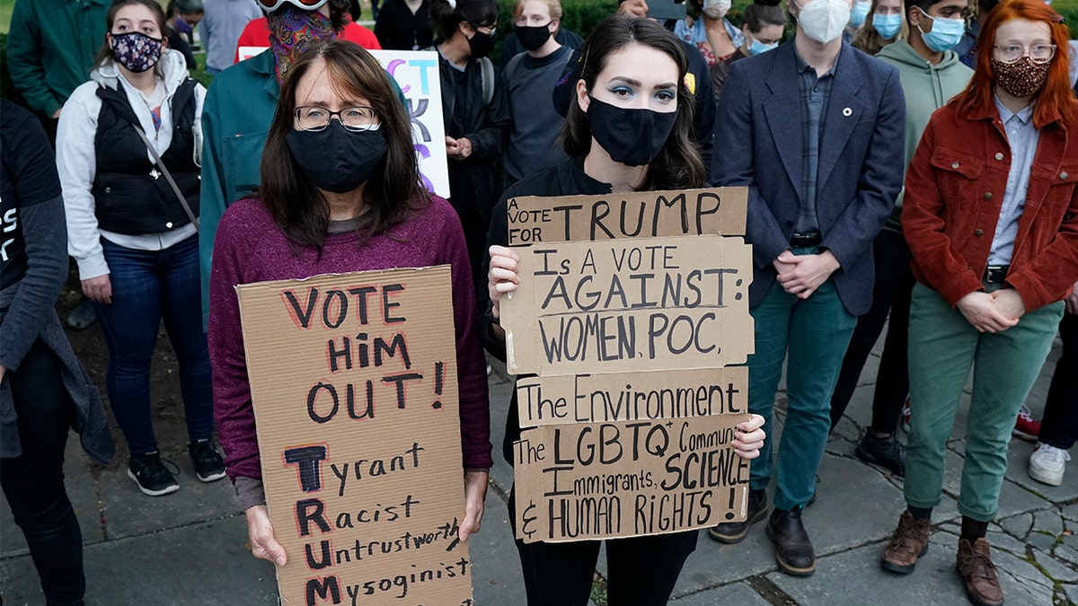 Protesters listen to speakers at a rally near the debate hall, Tuesday, Sept. 29, 2020, in Cleveland. The first presidential debate between Republican candidate President Donald Trump and Democratic candidate and former Vice President Joe Biden is being held in Cleveland on Tuesday. (AP Photo/Tony Dejak)