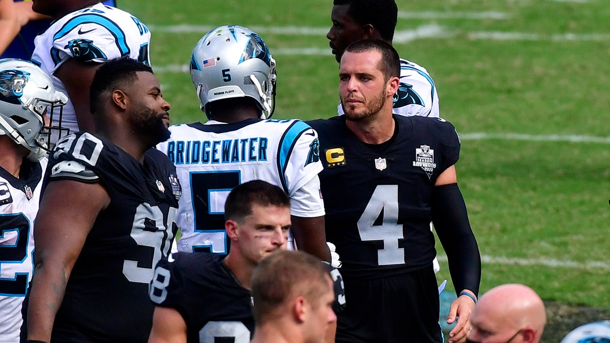 Las Vegas Raiders quarterback Derek Carr and Carolina Panthers quarterback Teddy Bridgewater meet on the field after an NFL football game Sunday, Sept. 13, 2020, in Charlotte, N.C. (AP Photo/Mike McCarn)