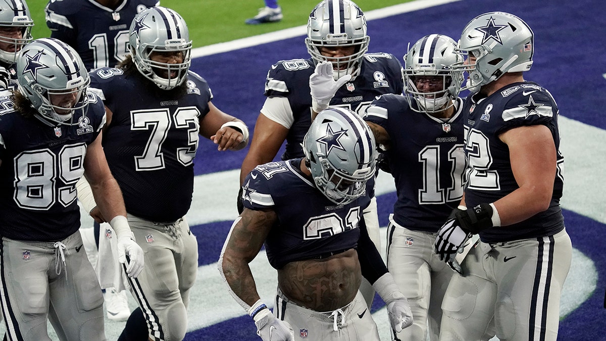 Dallas Cowboys running back Ezekiel Elliott (21) celebrates after scoring a touchdown against the Los Angeles Rams during the first half of an NFL football game Sunday, Sept. 13, 2020, in Inglewood, Calif. (AP Photo/Jae C. Hong )