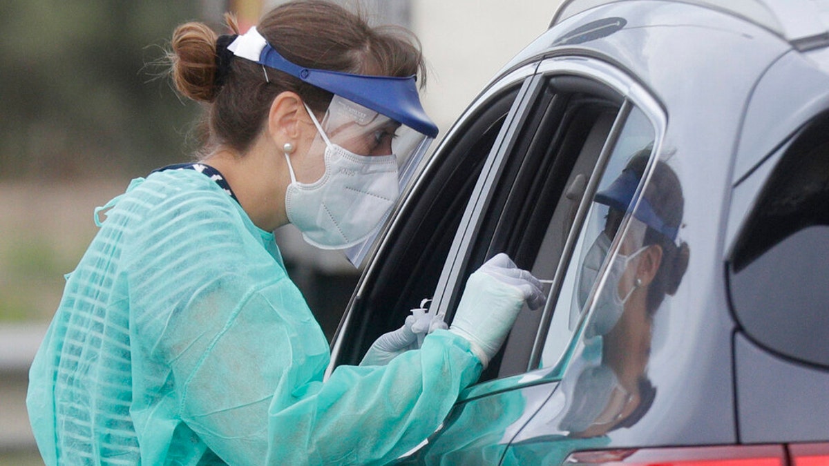 With help from the Italian Red Cross, Rome's Fiumicino Airport had also organized a drive-through testing center in an on-site parking lot, for the testing of travelers returning from higher-risk countries. (AP Photo/Gregorio Borgia)