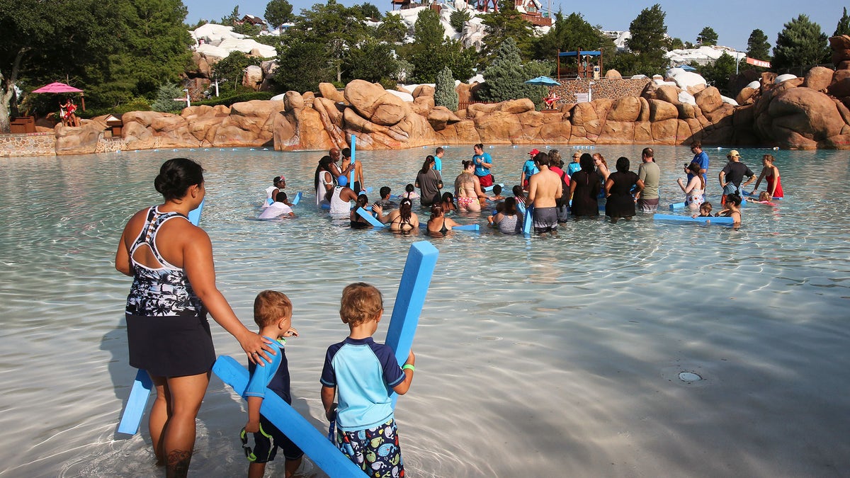 A woman and her sons at Disney's Blizzard Beach Water Park in June 2019. (Joe Burbank/Orlando Sentinel/Tribune News Service via Getty Images)