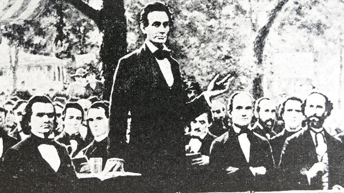 Abraham Lincoln (standing) in one of a series of seven debates regarding slavery with Stephen Douglas (at Lincoln's right), his rival for a seat in the Senate. These debates permitted both candidates to discuss their views on slavery. (Photo by: Universal History Archive/UIG via Getty images)