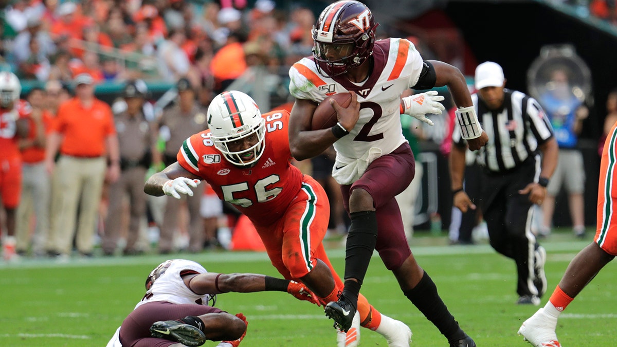In this Saturday, Oct. 5, 2019, file photo, Virginia Tech quarterback Hendon Hooker (2) runs as Miami linebacker Michael Pinckney (56) defends during the first half of an NCAA college football game in Miami Gardens, Fla. Virginia Tech plays North Carolina State on Saturday, Sept. 26. (AP Photo/Lynne Sladky)