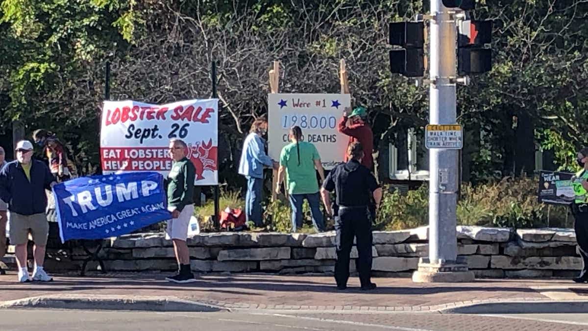 Pro-Trump protesters arrived at the intersection where the anti-Trump scoreboard was being displayed.