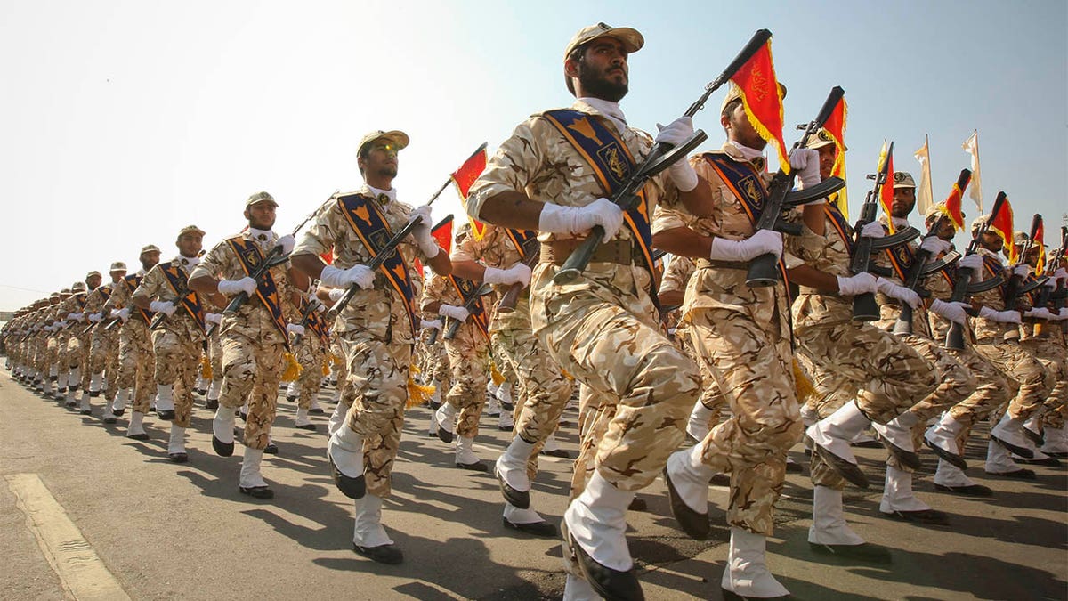 FILE- Members of the Iranian revolutionary guard march during a parade to commemorate the anniversary of the Iran-Iraq war