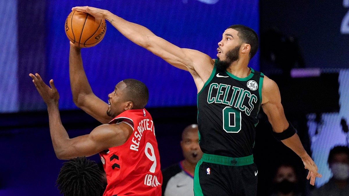 Boston Celtics' Jayson Tatum (0) blocks the shot of Toronto Raptors' Serge Ibaka (9) during the second half of an NBA conference semifinal playoff basketball game Monday, Sept. 7, 2020, in Lake Buena Vista, Fla. (AP Photo/Mark J. Terrill)