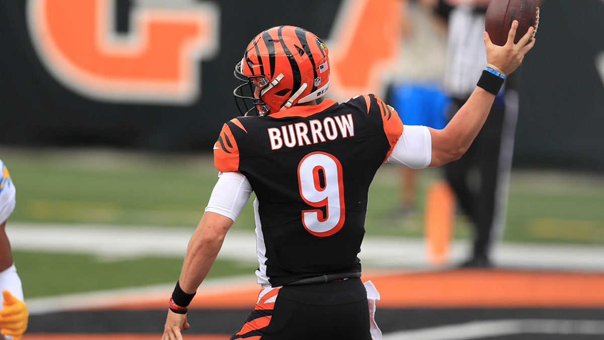 Cincinnati Bengals quarterback Joe Burrow (9) reacts after running for a touchdown during the first half of an NFL football game against the Los Angeles Chargers, Sunday, Sept. 13, 2020, in Cincinnati. (AP Photo/Aaron Doster)