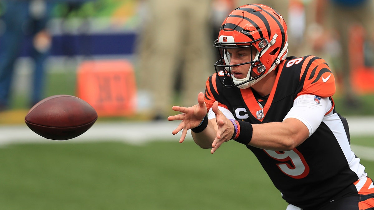 Cincinnati Bengals quarterback Joe Burrow (9) tosses the football during the first half of an NFL football game against the Los Angeles Chargers, Sunday, Sept. 13, 2020, in Cincinnati. (AP Photo/Aaron Doster)