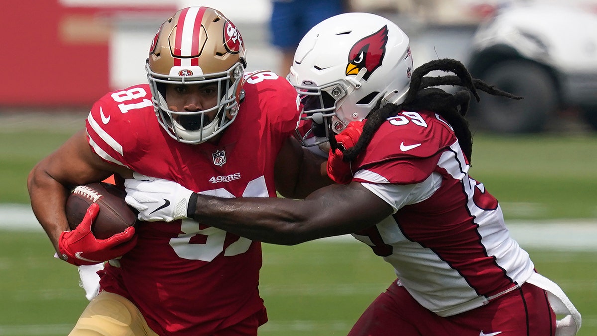 San Francisco 49ers tight end Jordan Reed (81) runs against Arizona Cardinals outside linebacker De'Vondre Campbell during the first half of an NFL football game in Santa Clara, Calif., Sunday, Sept. 13, 2020. (AP Photo/Tony Avelar)