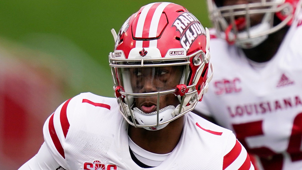 Louisiana-Lafayette quarterback Levi Lewis (1) runs from Iowa State defensive end JaQuan Bailey (3) during the first half of an NCAA college football game, Saturday, Sept. 12, 2020, in Ames, Iowa. (AP Photo/Charlie Neibergall)