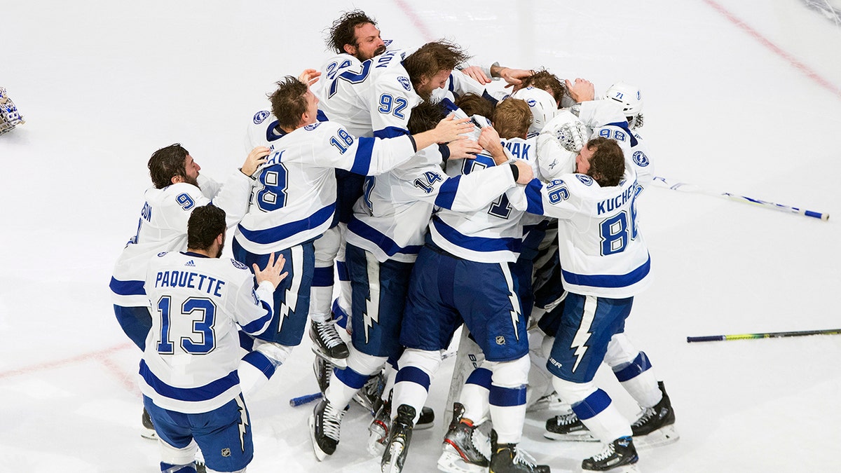 Tampa Bay Lightning players celebrate after defeating the Dallas Stars to win the Stanley Cup in Edmonton, Alberta, on Monday, Sept. 28, 2020. (Jason Franson/The Canadian Press via AP)
