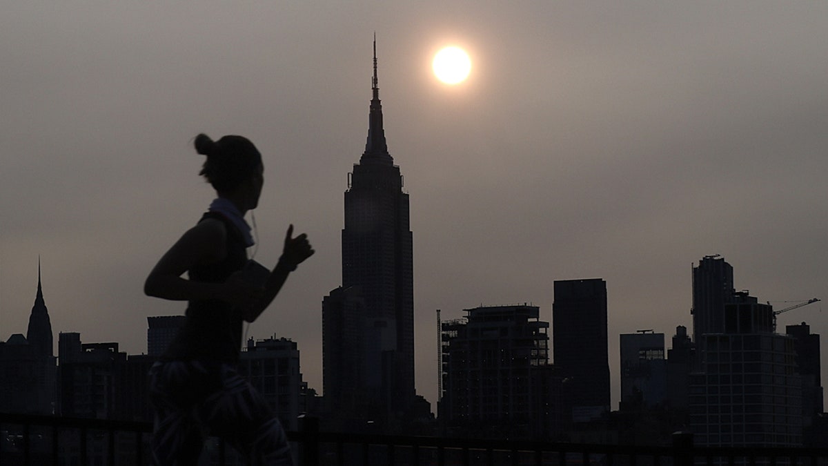 Sunrise behind the Empire State Building in New York City Tuesday morning in a haze created by smoke from the West Coast wildfires reaching the East Coast of the U.S.