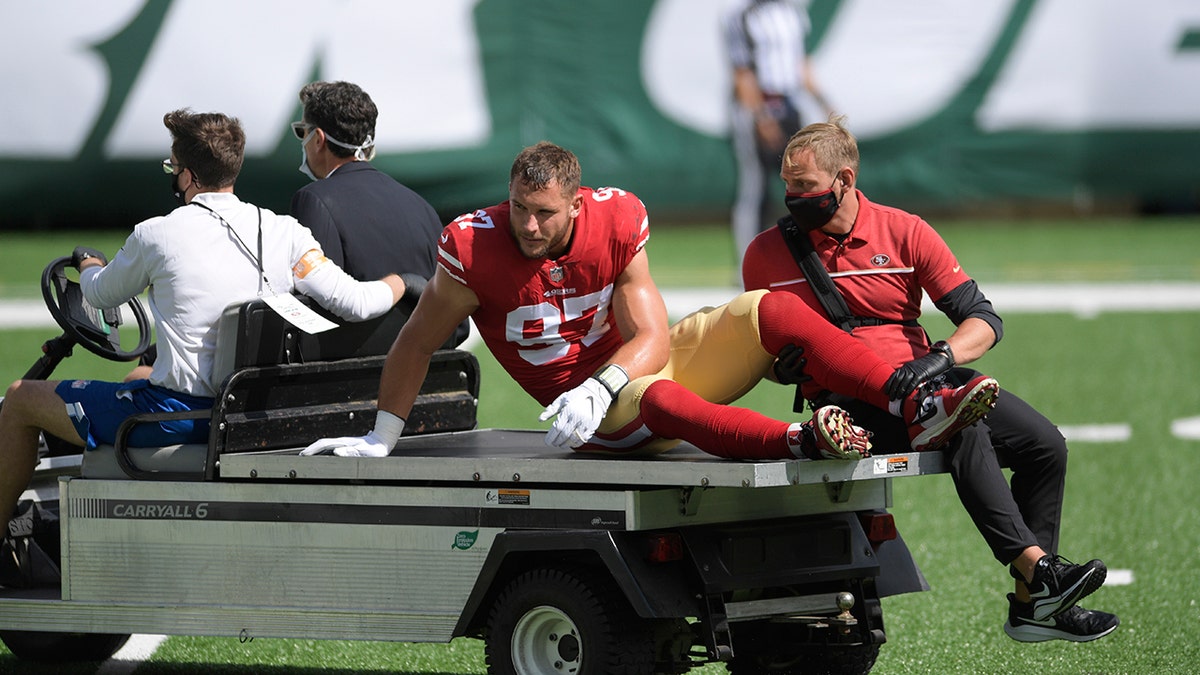 San Francisco 49ers defensive end Nick Bosa is carted off the field after being injured during the first half of an NFL football game against the New York Jets, Sunday, Sept. 20, 2020, in East Rutherford, N.J. (AP Photo/Bill Kostroun)