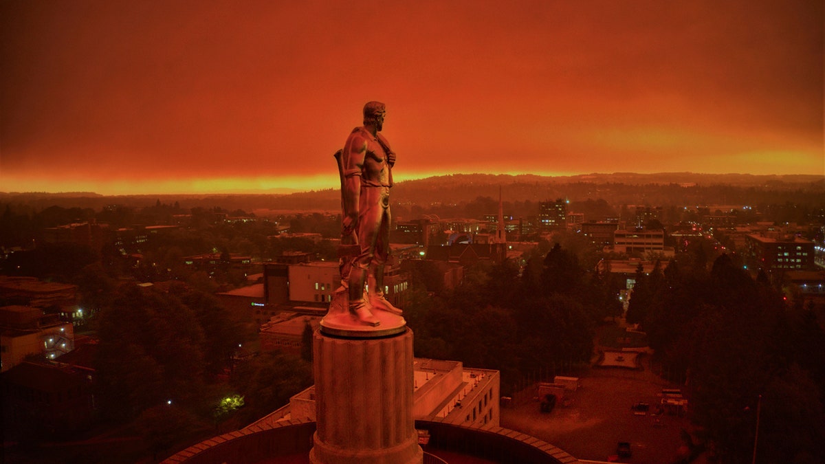 This drone photo provided by Michael Mann shows the Oregon Capitol building, with its "Oregon Pioneer" bronze sculpture atop the dome, with skies filled with smoke and ash from wildfires as a backdrop in Salem, Ore., on Sept. 8, 2020.