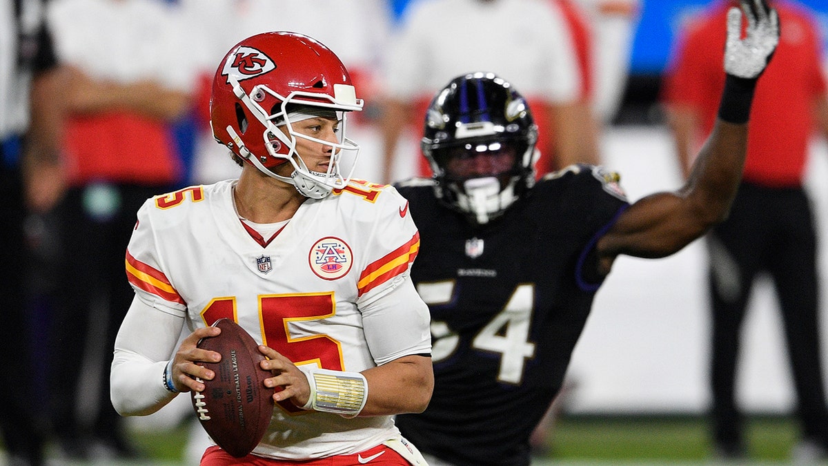 Kansas City Chiefs quarterback Patrick Mahomes (15) looks to pass under pressure from Baltimore Ravens linebacker Tyus Bowser (54) during the second half of an NFL football game, Monday, Sept. 28, 2020, in Baltimore. (AP Photo/Nick Wass)