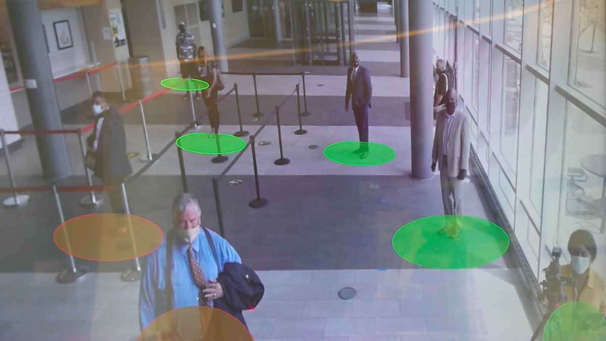 A social-distancing machine monitors if students are too close together.