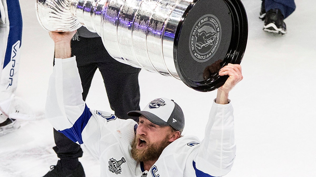 Tampa Bay Lightning center Steven Stamkos (91) hoists the Stanley Cup after defeating the Dallas Stars in Edmonton, Alberta, on Monday, Sept. 28, 2020. (Jason Franson/The Canadian Press via AP)