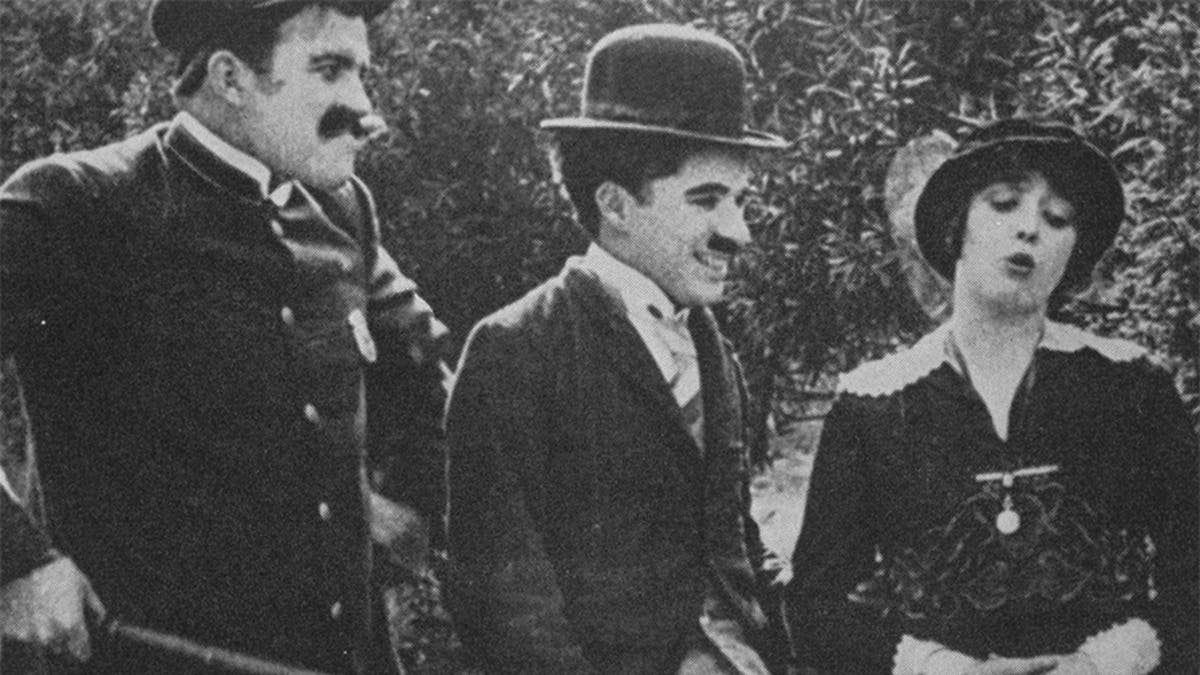 Charlie Chaplin (center) with Mabel Normand in the 1914 film 'Getting Acquainted.'