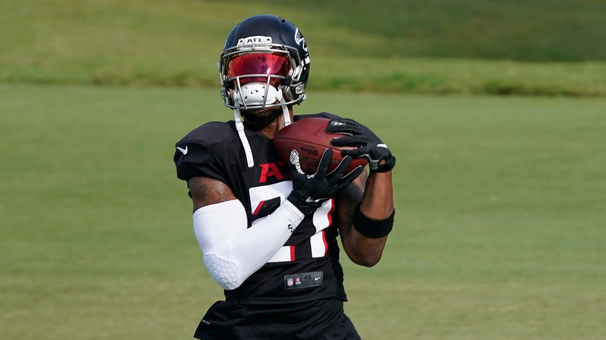 Atlanta Falcons running back Todd Gurley II (21) makes a catch during an NFL training camp football practice Thursday, Aug. 20, 2020, in Flowery Branch, Ga. (AP Photo/John Bazemore, Pool)