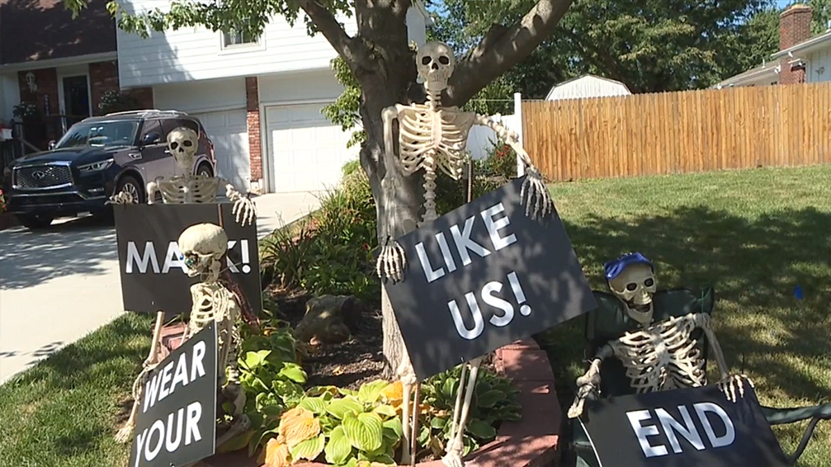 Kansas resident Kenneth Torres decorated his home for Halloween early this year to help remind his neighbors that wearing a mask can help prevent the spread of COVID-19. (WDAF)