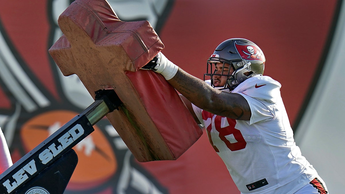 Tampa Bay Buccaneers 2020 first-round draft pick offensive tackle Tristan Wirfs works against a blocking sled during an NFL football training camp practice Monday, Aug. 24, 2020, in Tampa, Fla. (AP Photo/Chris O'Meara)