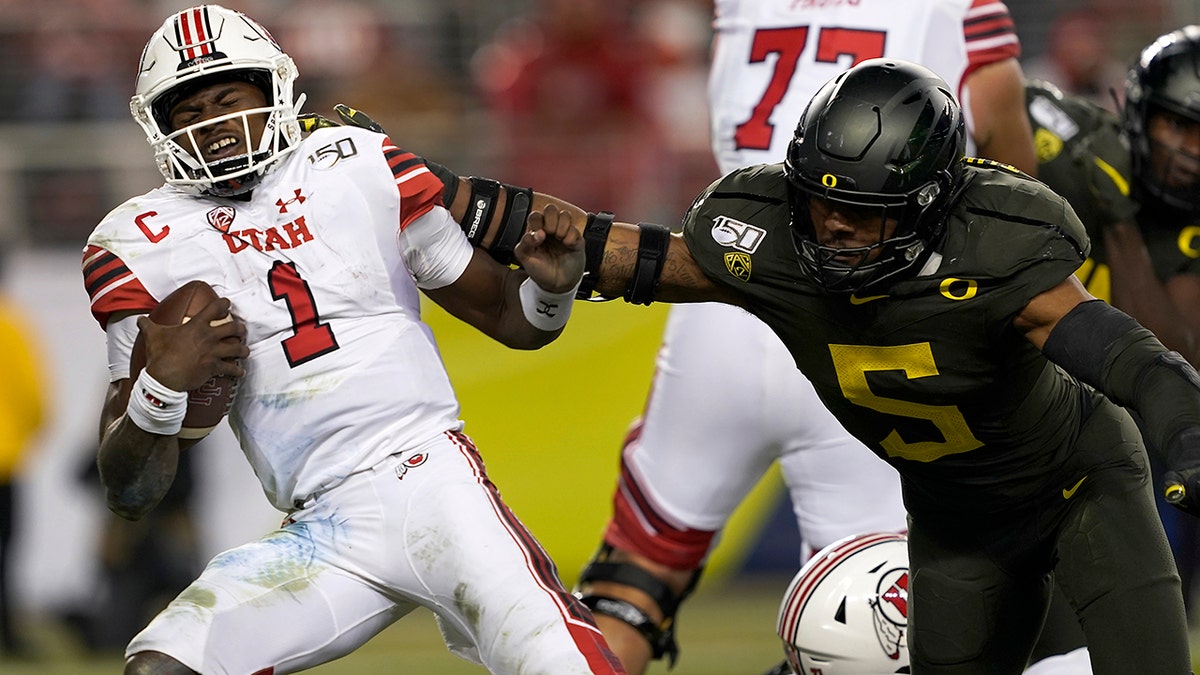 In this Dec. 6, 2018, file photo, Utah quarterback Tyler Huntley (1) is sacked by Oregon defensive end Kayvon Thibodeaux (5) during the second half of an NCAA college football game for the Pac-12 Conference championship in Santa Clara, California.