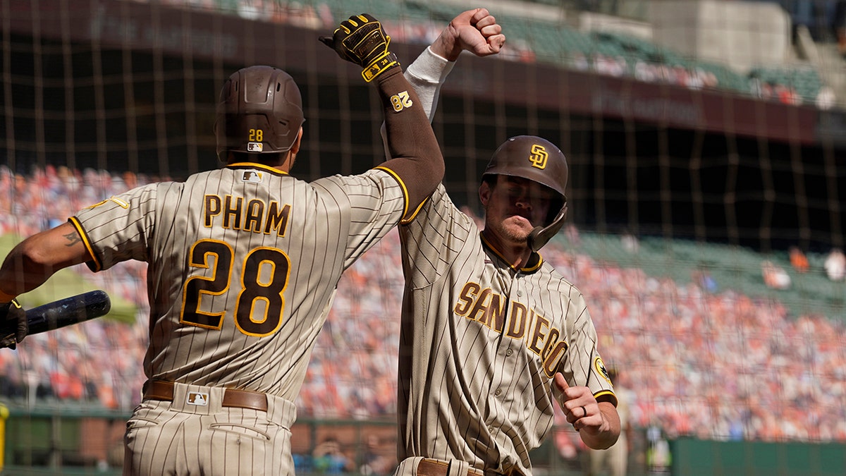 San Diego Padres' Wil Myers is greeted by teammate Tommy Pham (28) after hitting a home run off San Francisco Giants starting pitcher Drew Smyly in the second inning of a baseball game Sunday, Sept. 27, 2020, in San Francisco. (AP Photo/Eric Risberg)