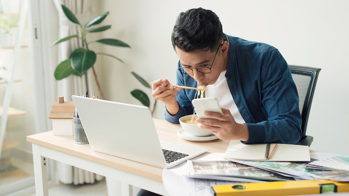 Cheerful engineer sitting in front of computer monitor