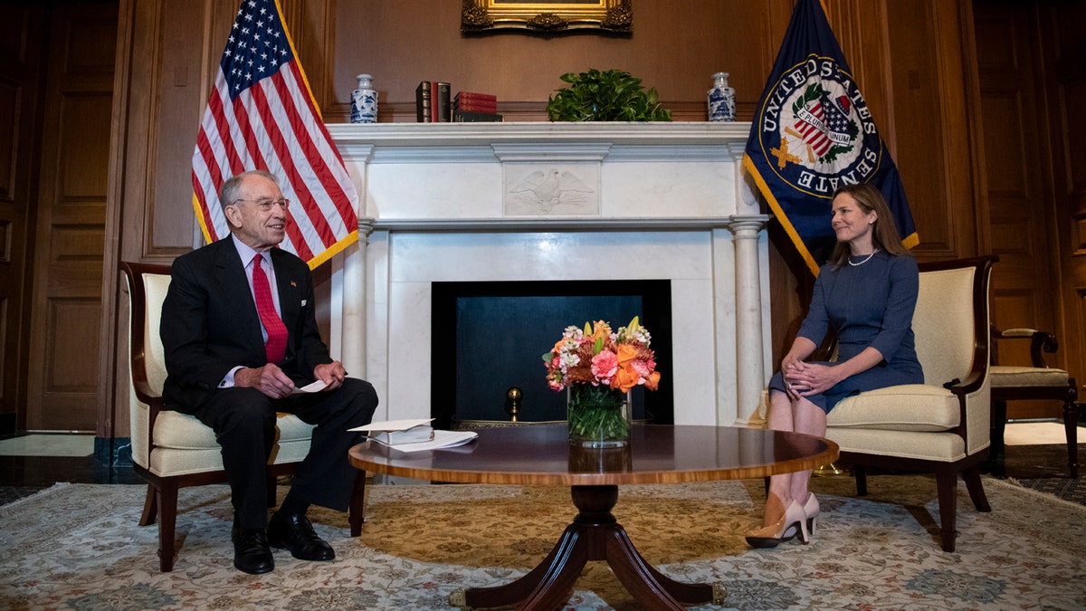 Judge Amy Coney Barrett, President Donald Trump's nominee to the Supreme Court, right, meets with Sen. Chuck Grassley, R-Iowa, at the Capitol, Tuesday, Sept. 29, 2020 in Washington. (Caroline Brehman/Pool via AP)