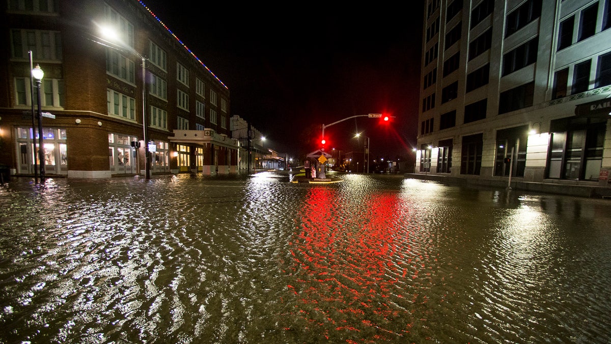 Water rises from the storm surge of Tropical Storm Beta in The Strand as the storm moves toward landfall late Monday, Sept. 21, 2020, in Galveston, Texas.