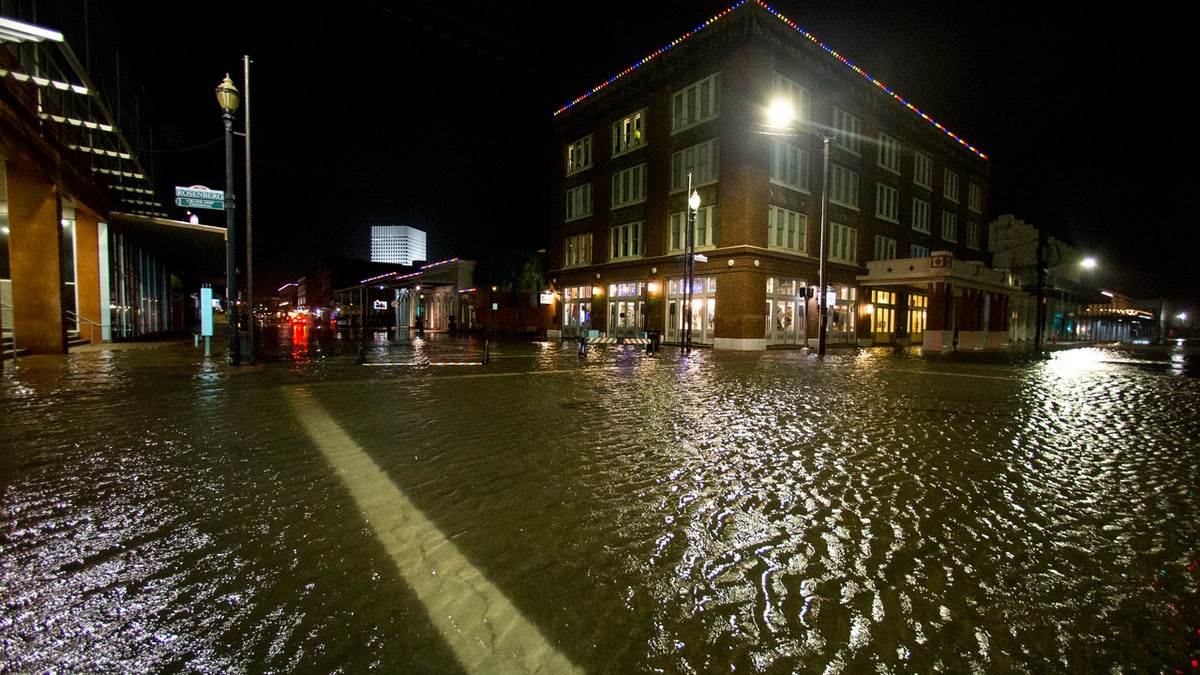 Water rises from the storm surge of Tropical Storm Beta in The Strand as the storm moves toward landfall late Monday, Sept. 21, 2020, in Galveston, Texas.