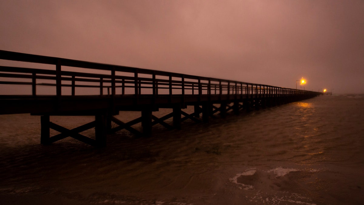 Waves crash against the pier at Kingfisher Park in Port O'Connor, Texas, as Tropical Storm Beta moved into the area Monday, Sept. 21, 2020.