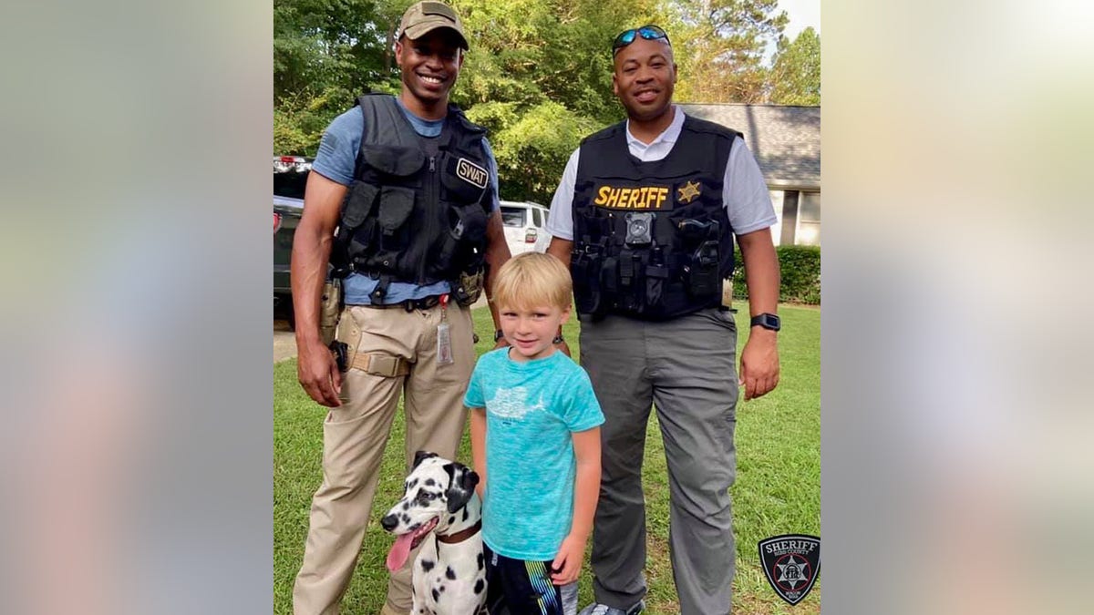 Deputies posed with the dalmatian and its young owner after reuniting the dog with its rightful family on Saturday.