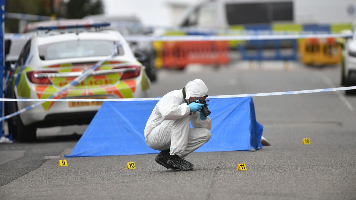 A police forensics officer taking photographs in Birmingham after several people were stabbed in the city center on Sunday. (AP/PA)