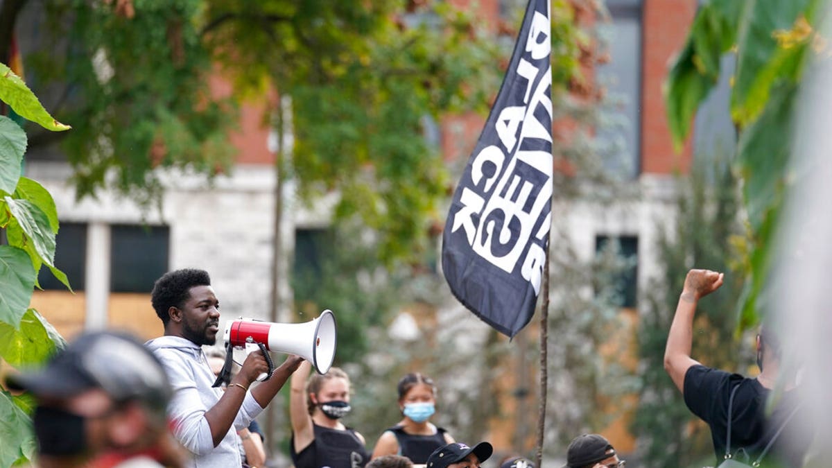 A man speaks to Black Lives Matter protesters, Friday, Sept. 25, 2020, in Louisville. (AP Photo/Darron Cummings)