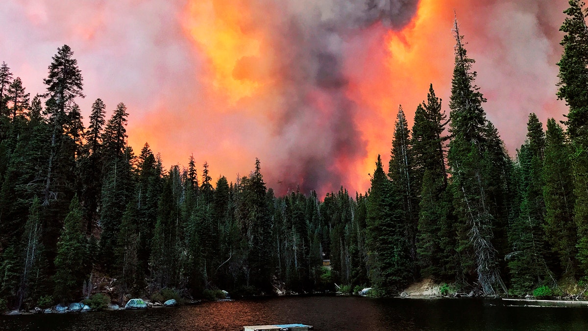 Smoke from the Creek Fire billows beyond a ridge as seen from Huntington Lake on Saturday, Sept. 5, 2020, at Huntington Lake, Calif.