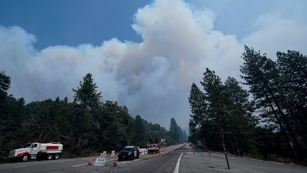 Smoke from the Creek Fire billows in the sky at a road closure Monday, Sept. 7, 2020, in Shaver Lake, Calif.